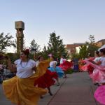 Dancers in colorful skirts performing a folkloric dance