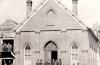 group of people standing in front of church building