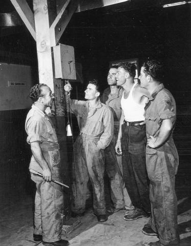 POWs Looking at Camp Clock