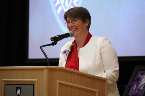 An image of Dr. Stacy Palen speaking from a podium, circa 2019