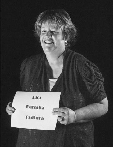 Dr. Maria Parrilla de Kokal holding a sign saying, "Dios Familia Cultura", Circa 2018